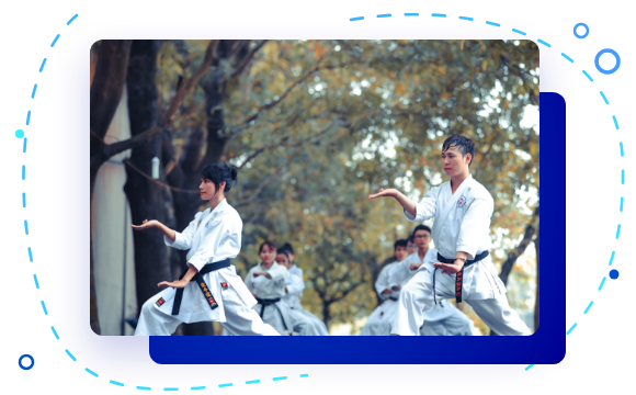 Martial arts students training outdoors