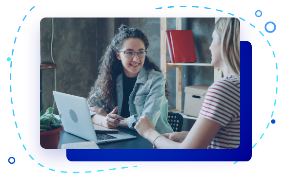 A team member walking a business owner through their new setup on a laptop