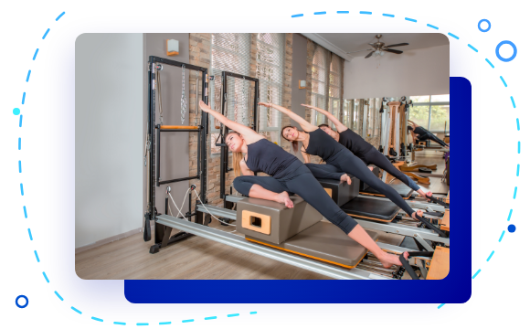 Pilates instructors training on reformer machines